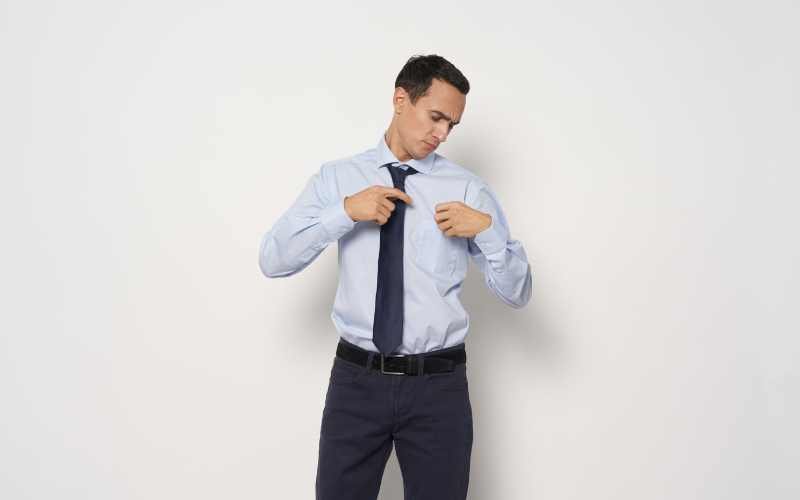 man checking his dress shirt